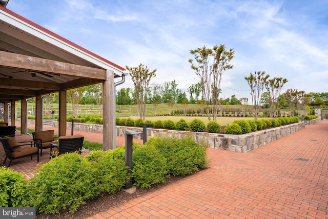 view of property's community featuring a patio and fence