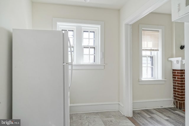 doorway featuring baseboards