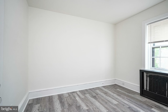 empty room featuring baseboards and wood finished floors