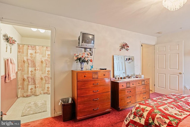 carpeted bedroom featuring ensuite bathroom