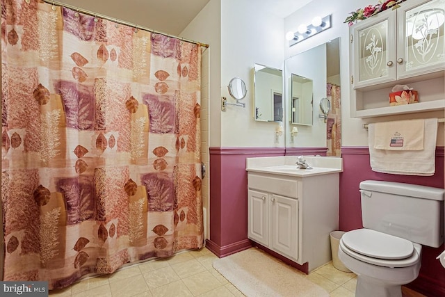 full bathroom featuring toilet, tile patterned flooring, and vanity
