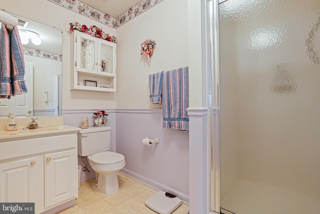 bathroom with toilet, a shower stall, tile patterned flooring, and vanity