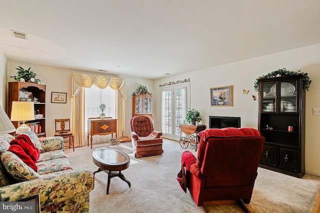 living room with visible vents and carpet