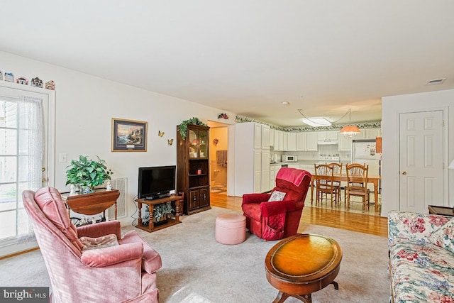 living area featuring visible vents and plenty of natural light