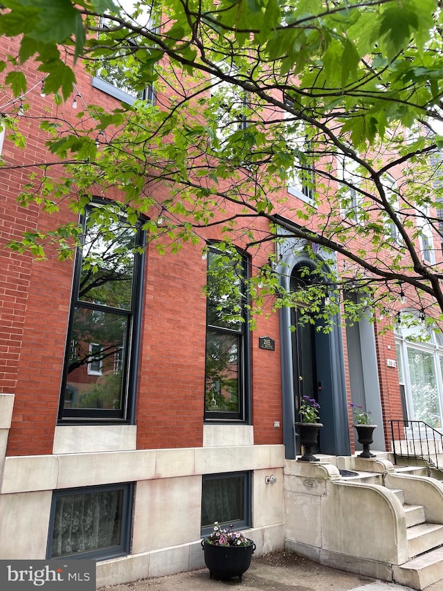 property entrance featuring brick siding