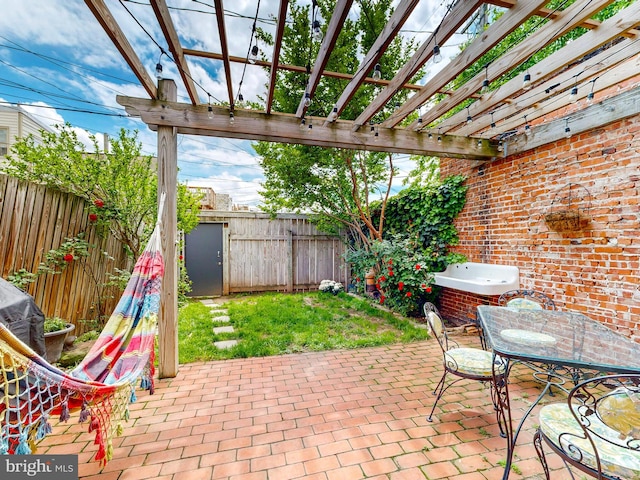view of patio / terrace with a fenced backyard, a pergola, and outdoor dining area