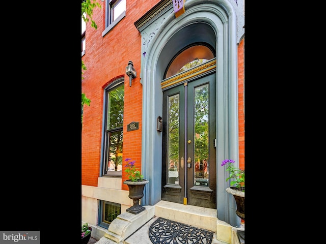 doorway to property with french doors and brick siding