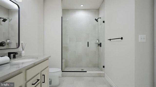 full bath featuring vanity, toilet, and a shower stall