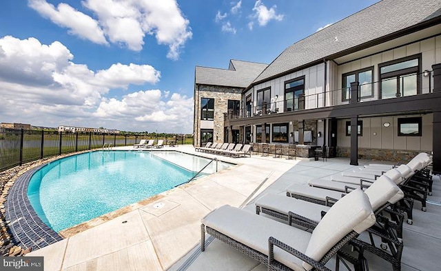 pool with fence and a patio area