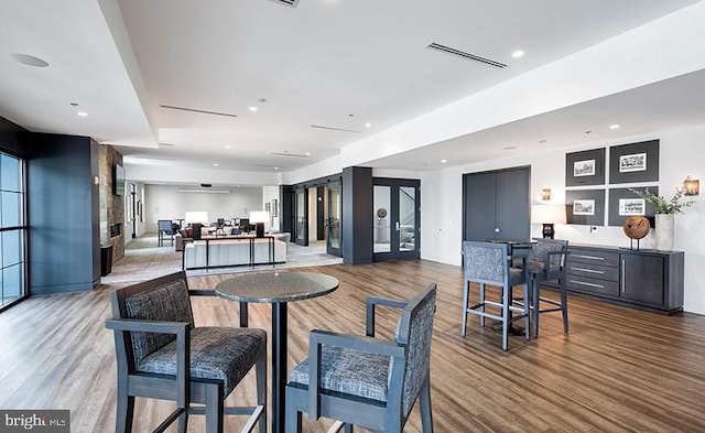 dining space with visible vents, baseboards, and wood finished floors