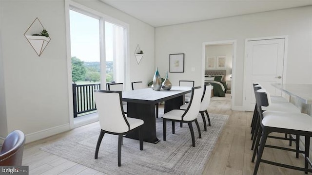 dining area featuring baseboards and light wood-style floors