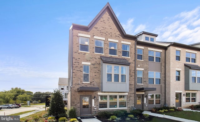 view of property featuring brick siding