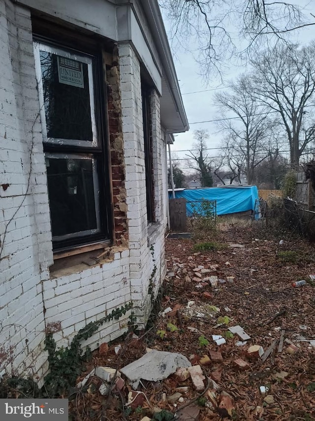 view of side of property featuring brick siding