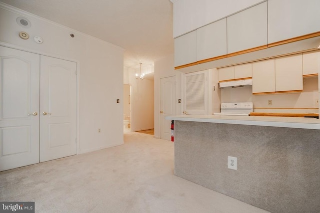 1211 S Eads St S Unit 401, Arlington, VA 22202 - kitchen with stove, under cabinet range hood, a chandelier, light carpet, and white cabinets
