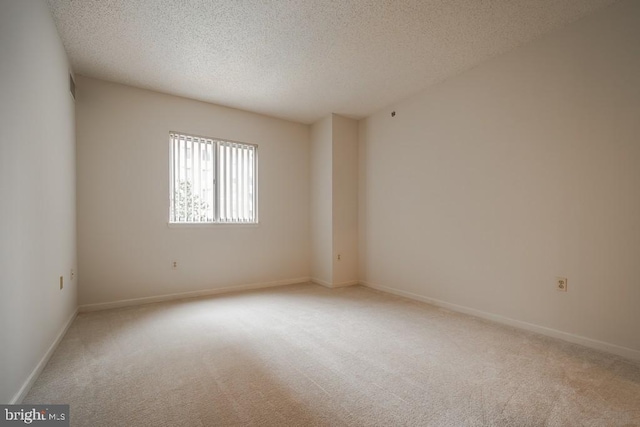 1211 S Eads St S Unit 401, Arlington, VA 22202 - spare room with light colored carpet, a textured ceiling, and baseboards