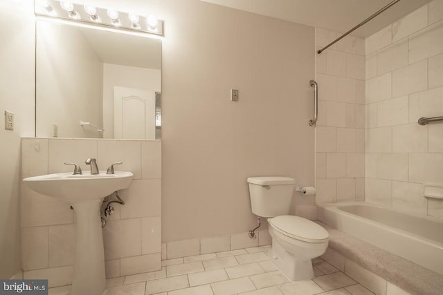 1211 S Eads St S Unit 401, Arlington, VA 22202 - bathroom featuring tile patterned floors, toilet, washtub / shower combination, and a sink