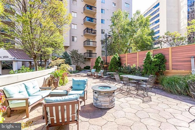 1211 S Eads St S Unit 401, Arlington, VA 22202 - view of patio / terrace with an outdoor living space with a fire pit, fence, and outdoor dining area