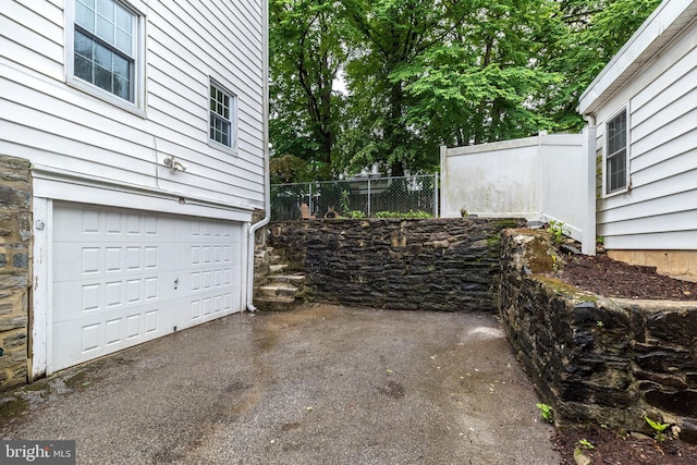 2948 Normandy Rd, Ardmore, PA 19003 - garage with fence and asphalt driveway
