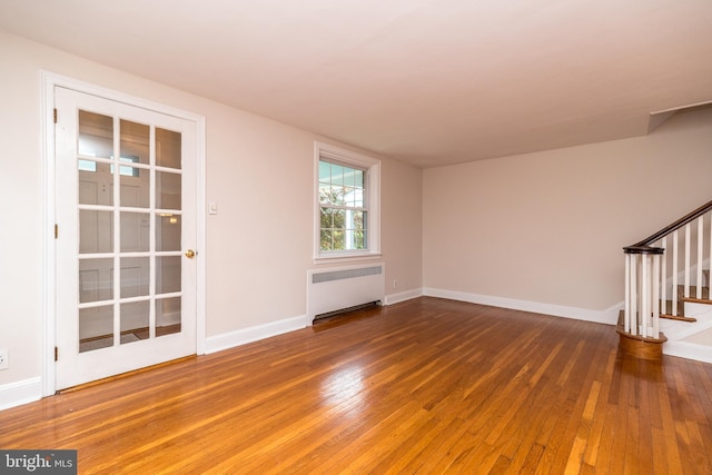 2948 Normandy Rd, Ardmore, PA 19003 - spare room with radiator, stairs, wood-type flooring, and baseboards