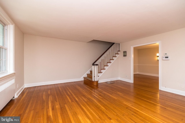 2948 Normandy Rd, Ardmore, PA 19003 - unfurnished living room featuring stairway, hardwood / wood-style floors, and baseboards