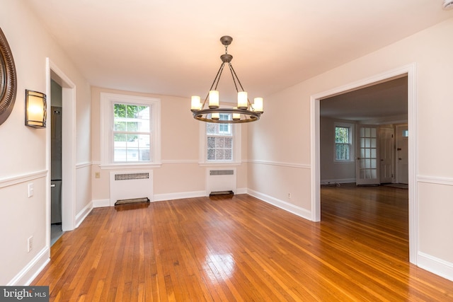 2948 Normandy Rd, Ardmore, PA 19003 - unfurnished dining area with radiator, a chandelier, hardwood / wood-style flooring, and plenty of natural light