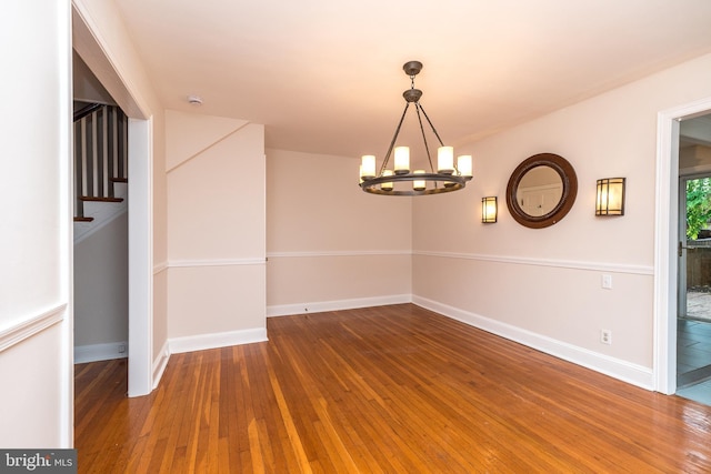 2948 Normandy Rd, Ardmore, PA 19003 - unfurnished dining area featuring a chandelier, wood-type flooring, baseboards, and stairway