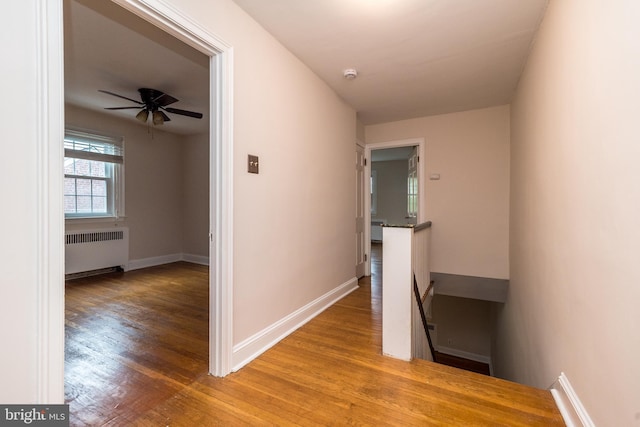 2948 Normandy Rd, Ardmore, PA 19003 - hallway featuring radiator, an upstairs landing, wood finished floors, and baseboards