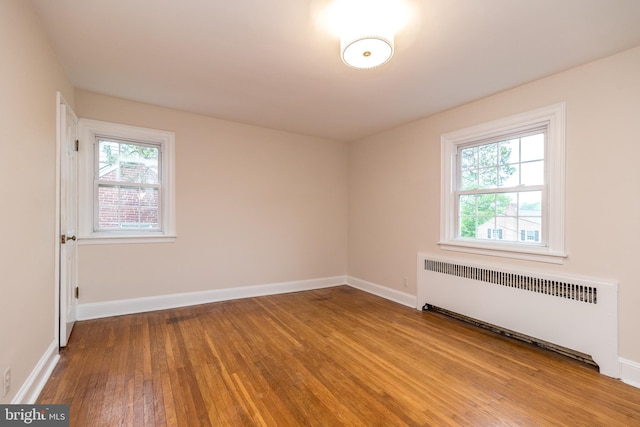 2948 Normandy Rd, Ardmore, PA 19003 - empty room featuring radiator heating unit, wood-type flooring, and baseboards