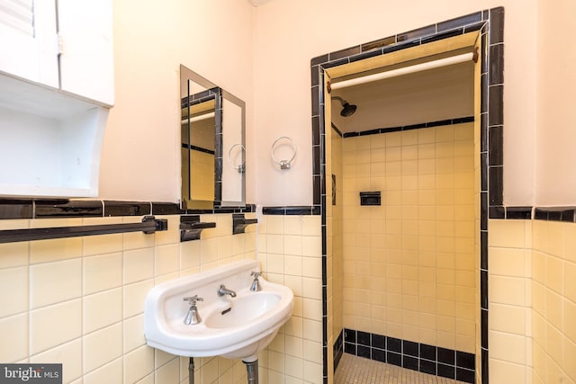 2948 Normandy Rd, Ardmore, PA 19003 - bathroom featuring a stall shower, a sink, tile walls, and a wainscoted wall