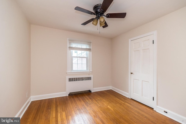 2948 Normandy Rd, Ardmore, PA 19003 - unfurnished room with radiator heating unit, hardwood / wood-style floors, baseboards, and ceiling fan