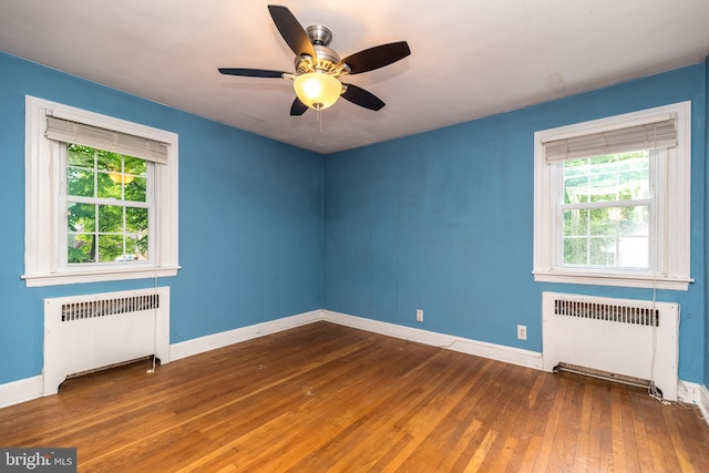 2948 Normandy Rd, Ardmore, PA 19003 - unfurnished room featuring radiator, healthy amount of natural light, and hardwood / wood-style floors