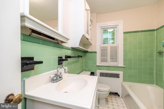 2948 Normandy Rd, Ardmore, PA 19003 - bathroom featuring radiator heating unit, tile walls, toilet, and vanity