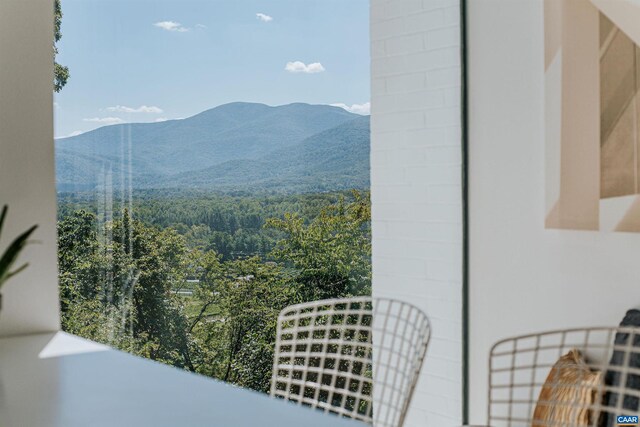 view of mountain feature with a forest view