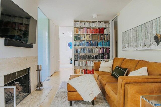 sitting room with wood finished floors and a premium fireplace