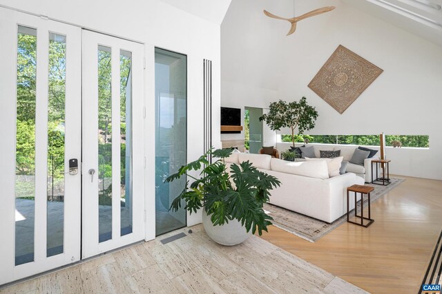 living area featuring high vaulted ceiling and wood finished floors