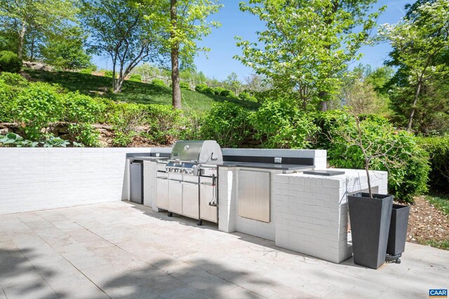 view of patio with area for grilling and exterior kitchen