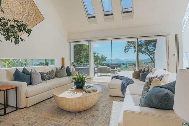 living area with high vaulted ceiling and a mountain view