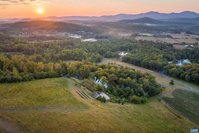 aerial view at dusk with a mountain view and a rural view