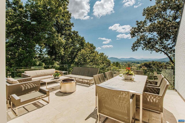 view of patio / terrace featuring a mountain view and an outdoor hangout area