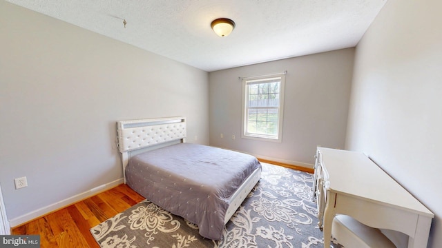 609 Quartzite Cir, Winchester, VA 22601 - bedroom with a textured ceiling, baseboards, and wood finished floors