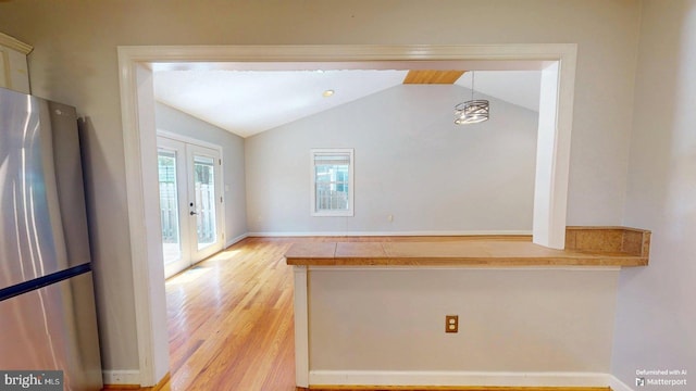 609 Quartzite Cir, Winchester, VA 22601 - interior space with freestanding refrigerator, light wood-style floors, french doors, vaulted ceiling, and hanging light fixtures