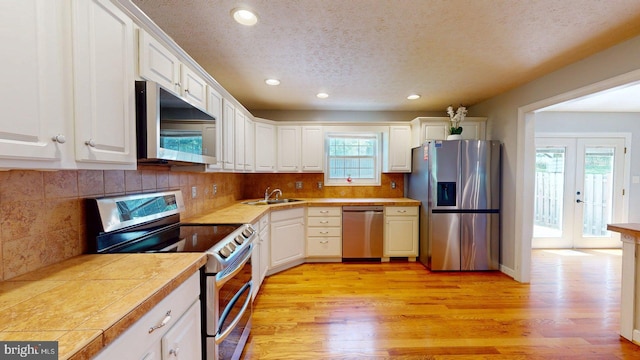 609 Quartzite Cir, Winchester, VA 22601 - kitchen with a textured ceiling, appliances with stainless steel finishes, a sink, white cabinets, and recessed lighting