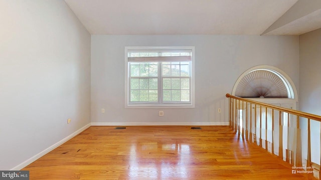 609 Quartzite Cir, Winchester, VA 22601 - unfurnished room with baseboards, vaulted ceiling, and wood finished floors