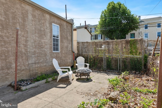 view of patio / terrace with an outdoor fire pit and fence