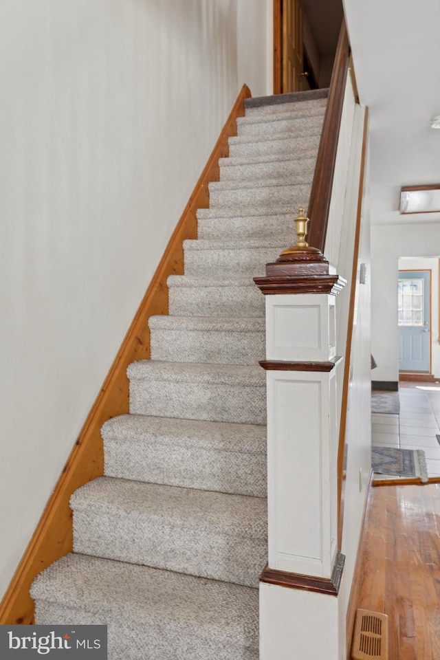 stairway featuring wood finished floors