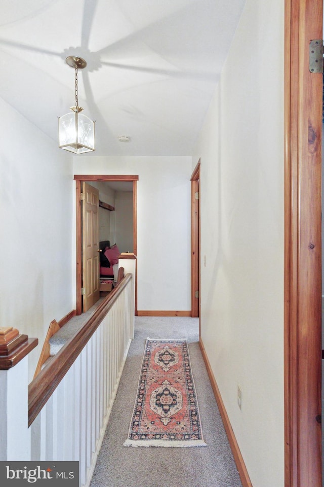 corridor featuring carpet floors and baseboards