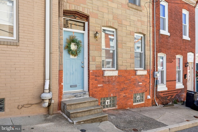 view of exterior entry with brick siding