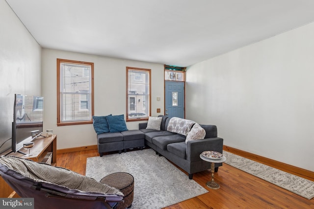 living room featuring baseboards and wood finished floors