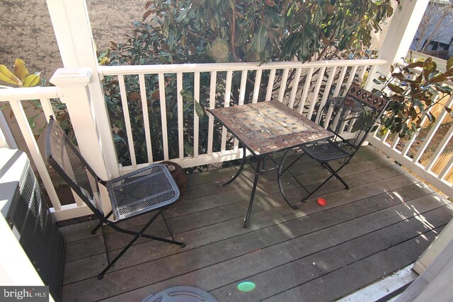 wooden terrace featuring outdoor dining area