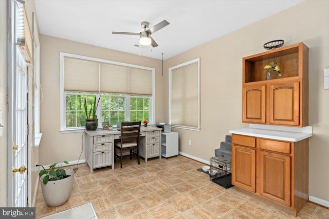 office area with baseboards and a ceiling fan